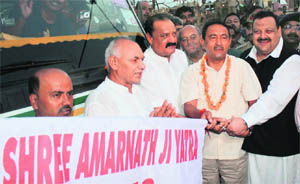 Minister for Tourism and Culture Nawang Rigzin Jora (second from right), Chief Ministers Political Adviser Devinder Singh Rana (extreme right) and Minister for Industries and Commerce Surjit Singh Slathia (third from left) flag off the first batch of Amarnath pilgrims from the Jammu base camp in Bhagwati Nagar on Sunday.