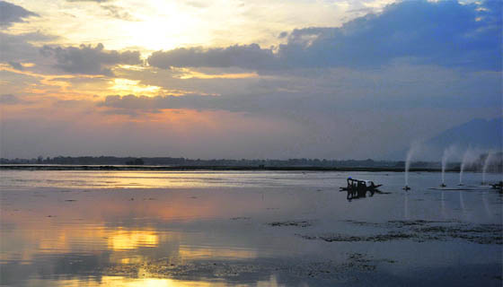 Tourists enjoy a ride in a shikara in Srinagar on Sunday.