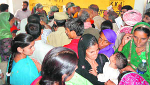 A huge rush of patients during a free medical camp at a hospital in Kalakote on Sunday. 