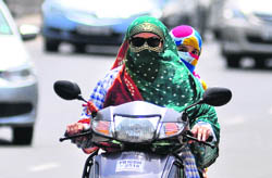 Girls brave the heat on a humid afternoon in Ludhiana on Sunday. 