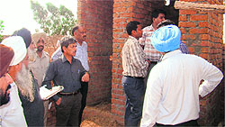 Officials inspect newly built toilets in Sham Khera village