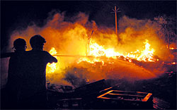 Firemen try to douse the flames at a scrapyard on the Amritsar-Attari bypass