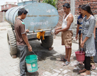 In the absence of water supply network, residents are dependent on the municipal corporation water tank, in Amritsar. 