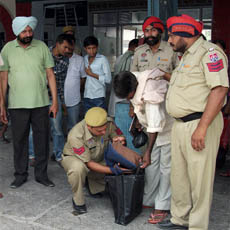 GRP men frisk passengers and check their luggage at Abohar. 