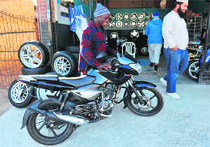 A worker moves a motorbike in Alexandra, South Arica. Indian motorcycle manufacturers want to flood South Africas townships with cheap bikes, despite there being no local culture of two-wheelers that rule the road elsewhere in Africa. "South Africa is a very particular market," said Karan Patni, southern Africa marketing manager for Bajaj, which has opened four outlets around Johannesburg to target the untapped bike market.