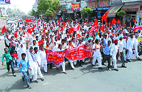 Members of various labourers unions hold a protest march against Punjab Government in Bathinda on Monday.