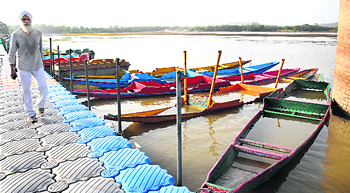 Shikaras lie grounded at Sukhna Lake due to the low water level in the lake.