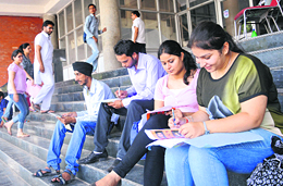Students fill admission forms in Panjab University on Monday.