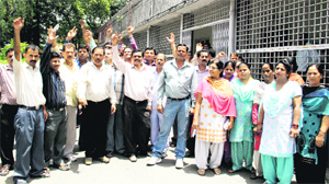Collectorate employees raise slogans at the District Magistrates office in Dehradun on Monday.