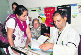 A government doctor at Doon Hospital wears a black band in support of private doctors who were on strike in Dehradun on Monday.