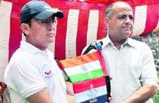 Uttarakhand DGP Vijay Raghav Pant presents the police flag to DIG Sunjay Gunjial in Dehradun on Sunday. 