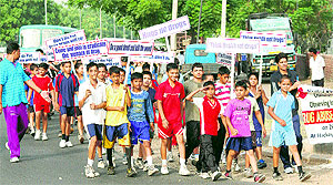 Players and coaches participate in a rally organised by the UT sports department on the International Day against Drug Abuse and Illicit Trafficking in Chandigarh on Tuesday