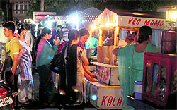 People enjoy food at a stall in Jammu on Tuesday