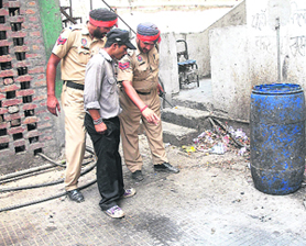 Police personnel inspect the spot on the premises of Grand Mall, where she was found lying unconscious, in Jalandhar on Tuesday.