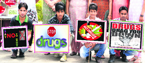 Say no to drugs Youths show placards bearing messages against drug addiction on International Day Against Drug Abuse in Jalandhar on Tuesday.