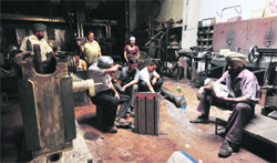 Nothing to do: Industry workers sit idle in a factory following a power cut in Ludhiana. Tribune photo: Himanshu Mahajan