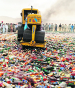 A steamroller crushes bottles of liquor during a ceremony to mark International Day against Drug Abuse and Illicit Trafficking in Karachi. 