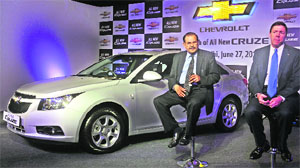 General Motors India president & managing director Lowell Paddock (L) and vice president, corporate affairs, P. Balendran pose with the completely new diesel variant of the Chevrolet Cruze at its launch in New Delhi on Wednesday. The premium sedan, which has raised its own bar with the next-gen VCDi engine, unleashing 166 PS and 380 Nm torque, is powered by a 2-litre diesel engine with a 6-speed manual transmission and is priced between Rs 13.85 lakh and Rs 15.67 lakh (ex-showroom in Delhi).  Tribune photo by Manas Ranjan Bhui