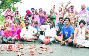 Residents of the Dadu Majra Colony protest against poor supply of water in Chandigarh on Wednesday. 