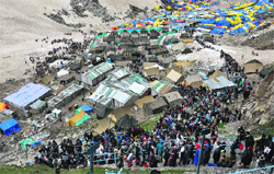 Devotees wait for their turn outside the holy cave at the Amarnath shrine in south Kashmir.Tribune photo: Anand Sharma
