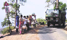   Villagers beg for water from an Army vehicle at Ghani in Krishna Ghati, Poonch district. 