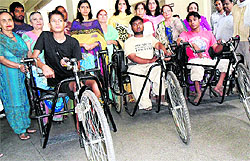 Ritu Aggarwal, wife of the Deputy Commissioner, distributes trycycles among physically-challenged persons at District Red Cross Bhawan in Amritsar on Thursday