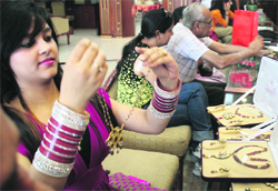 A woman checks out a piece of jewellery at a shop in Jammu. Tribune photo: Inderjeet Singh