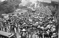 People stranded on a road following monsoon showers in Mumbai on Thursday.  PTI