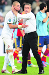 Portuguese defender Pepe is comforted by head coach Paulo Bento after they lost to Spain.  AFP 