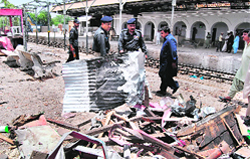 Police officials at a railway station where a bomb explosion took place in Balochistan.  AFP