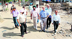 Improvement Trust chairman Sanjiv Sharma (centre) visits the under-construction flyover at Kitchlew Chowk in Amritsar on Friday