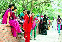 Many sit under the trees on the Guru Nanak Dev University campus in Amritsar on Friday