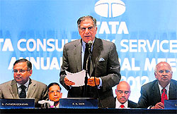 Tata Consultancy Services chairman Ratan Tata (standing) speaks as vice-chairman S. Ramadorai look on during the annual general meeting of TCS, part of the steel-to-tea Tata conglomerate, in Mumbai on Friday. India's biggest outsourcing firm reported its net profit jumped 23 per cent in January-March, beating market forecasts as US and European customers boosted orders. Net profit was Rs 29.32 billion (US $558 million) for the fiscal fourth quarter