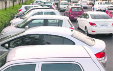 Cars parked on a road to the Rajiv Gandhi Chandigarh Technology Park. 