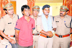 Injured Sub-Inspector Dharmendra Rathi with arrested criminal Raees Ahmed at Jwalapur Kotwali in Haridwar on Friday.