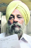 Gurbhajan Singh Bajwa, the government contractor,shows an FIR and documents to substantiate his points in Ludhiana on Friday. Photo: Inderjeet Verma 