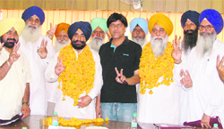 Re-elected chairman (left in garland) Ajmer Singh Bhagpur and vice-president (right in garland) Amrik Singh Rauni of Verka Milk Plant in Ludhiana on Friday. Tribune photo: Inderjeet Verma