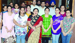 Meritorious students of BBK DAV College pose for a photograph with their teachers in Amritsar on Saturday.Photo: Sameer Sehgal