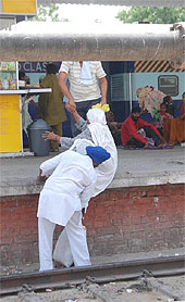 A man helps an elderly woman climb a platform at the Bathinda railway station. Though the effort of the woman, despite her age, is laudable, it certainly is not the right way as it could have endangered her life in case a train arrived at that very moment.