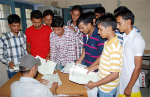 Students submit their admission forms for various courses at Government Rajindra College on Saturday.