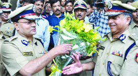 New Police Commissioner Neeraj Kumar (right) being greeted by his predecessor BK Gupta in New Delhi on Saturday.