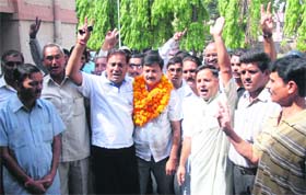 BJP candidate Bhupinder Farasi, along with his supporters, after winning the Municipal byelection in Dehradun on Saturday