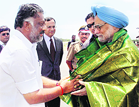 Prime Minister Manmohan Singh being presented a shawl by Tamil Nadu Finance Minister O Panneerselvam in Chennai