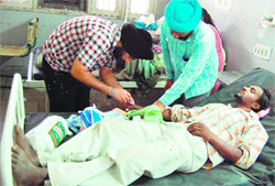Doctors attend to an injured forest official at GND Hospital in Amritsar. Photo: Sameer Sehgal