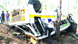 A policeman inspects the PRTC bus that met with an accident near Kauli village in Patiala on Saturday. Tribune photo: Rajesh Sachar 