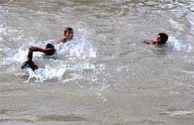 Just chill! Children make a splash as they take a dip in the waters of the Sirhind Canal in Bathinda on Sunday afternoon