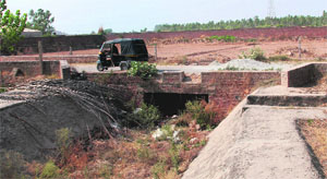 A seasonal drain being choked by illegal construction near Dera Bassi.