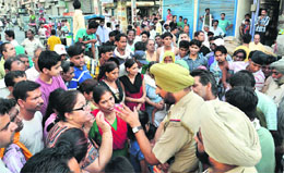 A policeman tries to pacify residents of Subash Gate in Karnal on Sunday. 