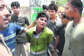 The youth, who allegedly raped a three-year-old girl, being thrashed by residents in Jalandhar on Sunday