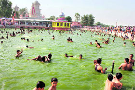 Devotees take a dip during the annual fair at the shrine of Baba Sidh Gori in Samba on Sunday.